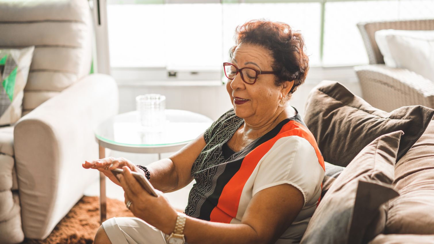 Medicaid member reviews contact information on her phone